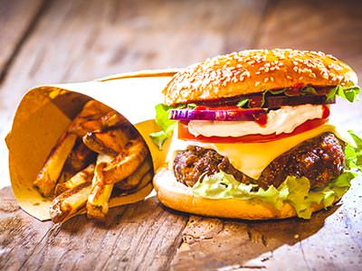 A cheeseburger and fries on a wooden table