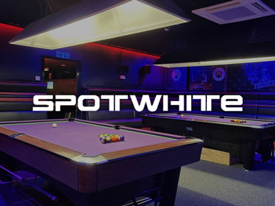 A close up of a purple pool table with pool balls on, with other similar tables visible in the background at Spot White in Newcastle