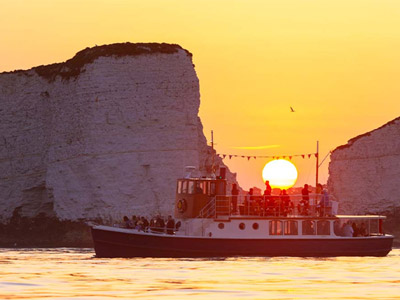 A blue and white party boat boat on the waters around Bournemouth