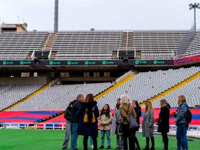 Barcelona FC logo over a blurred image of the pitch at Nou Camp