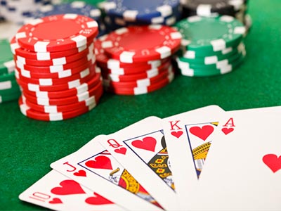 Poker chips laid out behind a deck of cards