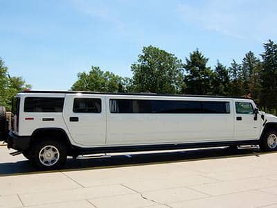 A white hummer, parked up during the day