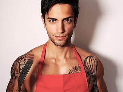 A semi-naked man in a red apron