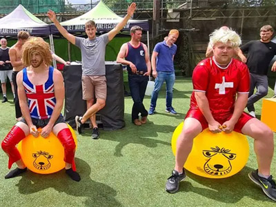A group of men dressed up on bouncy balls