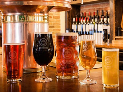 Lots of sample beers lined up on a bar