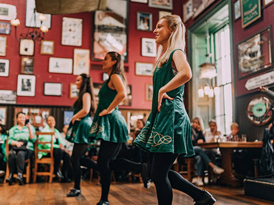 A hen group in Dublin dancing in an Irish bar