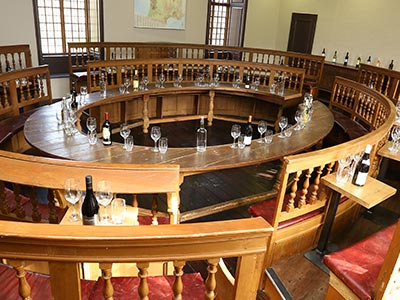 Some circular benches with glasses on for whisky tasting