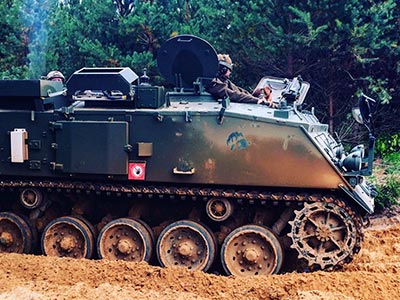 A tank driving through the sand 