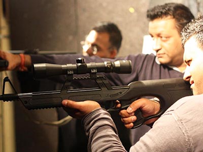 Some men firing guns in a shooting range