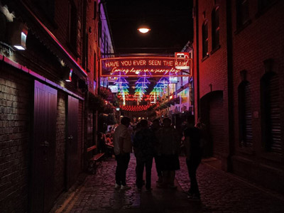 Two men and two women having drinks in a red booth in a club