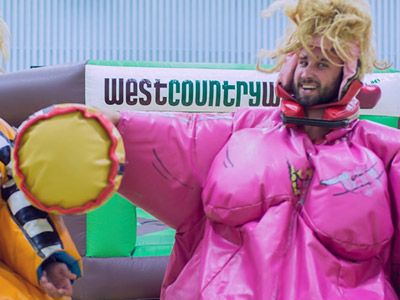 A man dressed up as Vicky Pollard playing a game at West Country Games
