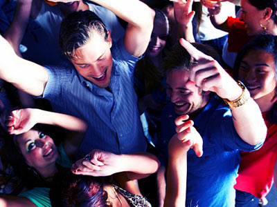 A group of men and women dancing in a club