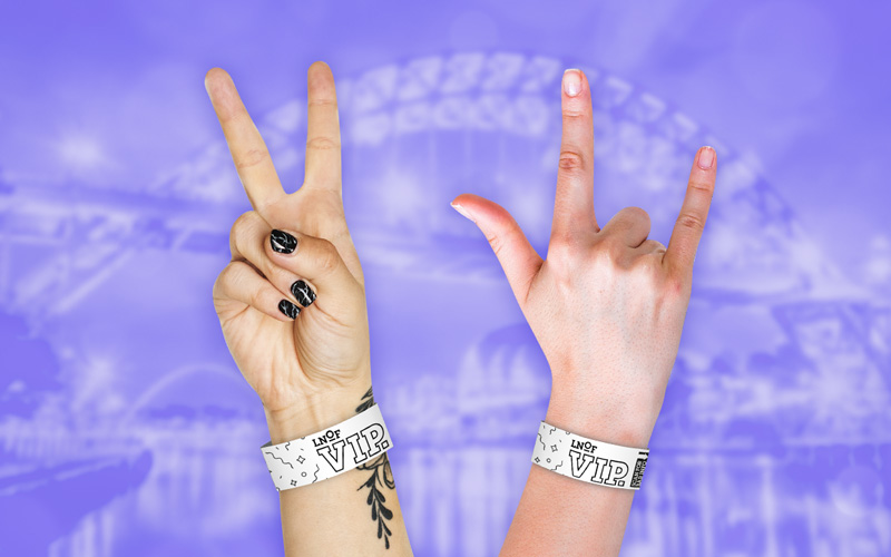 Hand doing a party horns sign wearing a Newcastle Nightlife Wristband with the text Become a LNOF VIP