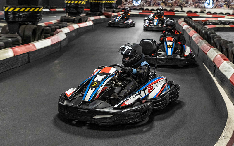 Some people racing in go karts 