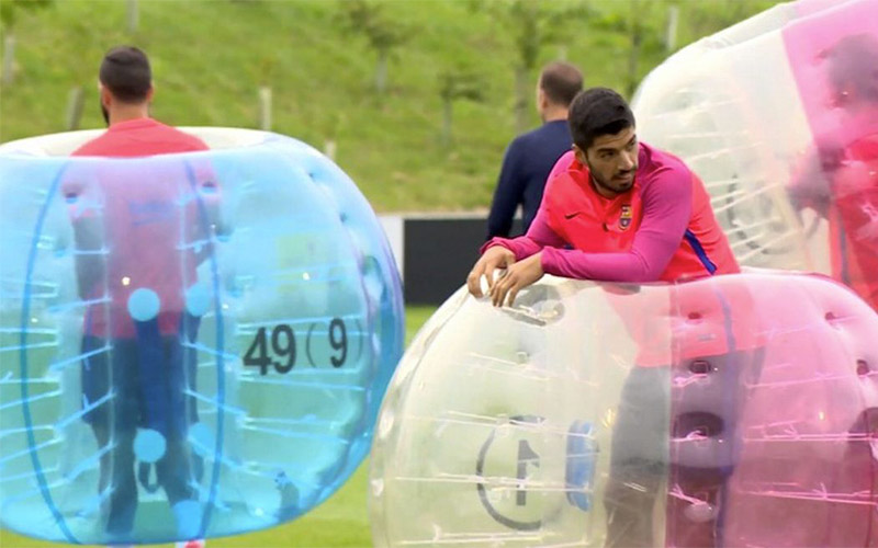 A couple of men stood up in their inflatable bubbles