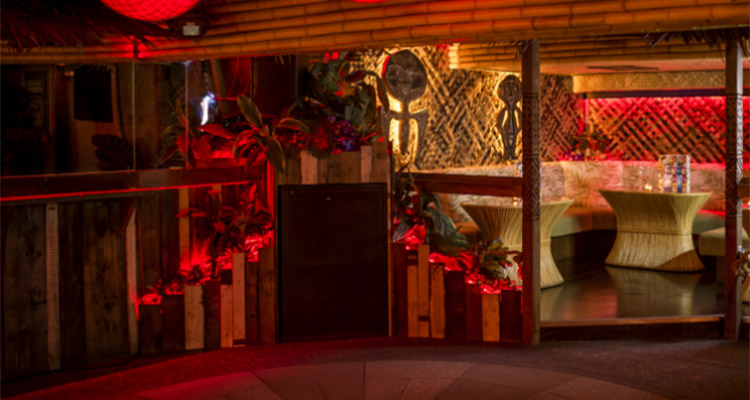 A Tiki themed bar with booth seating 