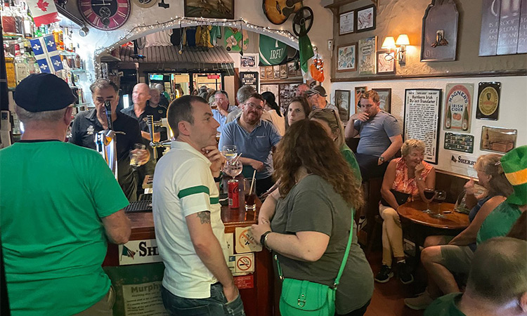 A group of people stood at the bar at Sherry's Irish Bar