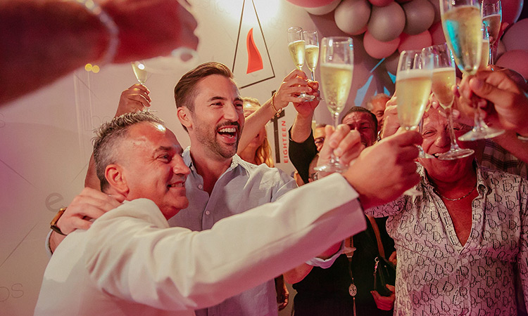 A group of people clinking glasses of fizz at Libertos Club