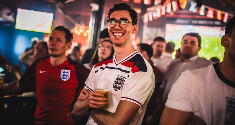 Some men watching the football 