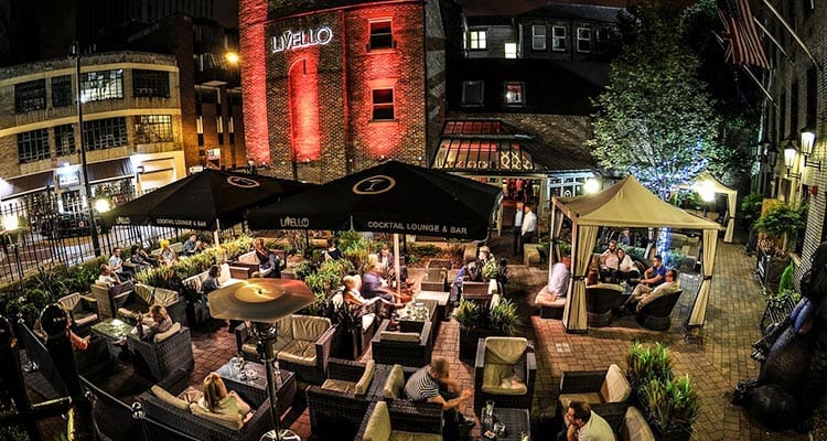 Image of the outside view of livello with seating and marques with standing electric heaters and lighting