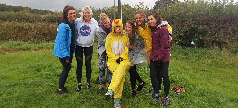 A group of women and one woman dressed as a duck