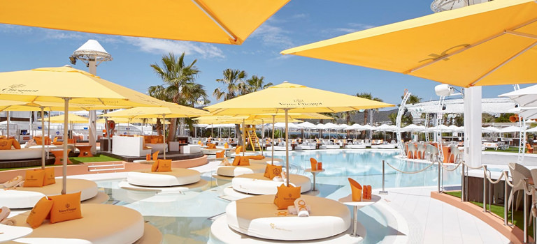 A poolside area with sunloungers and parasols