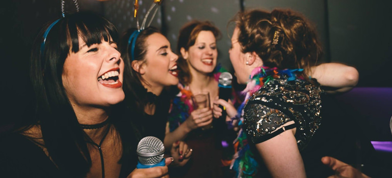 Some girls in a nightclub singing