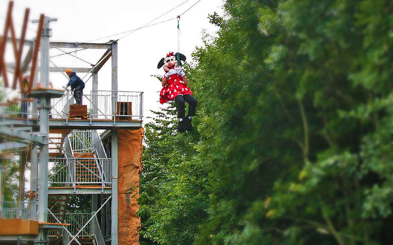 Someone zipwiring wearing a Minnie Mouse costume