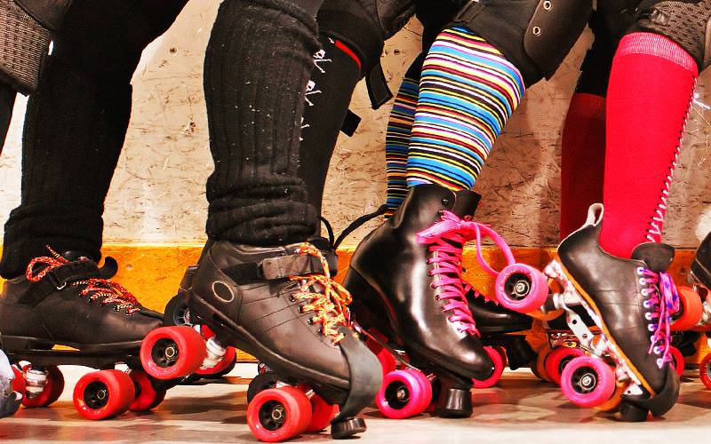 A close up of some women wearing rollerblades