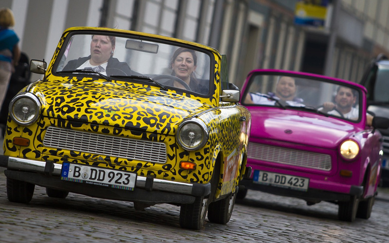 People driving two minis through Berlin city centre