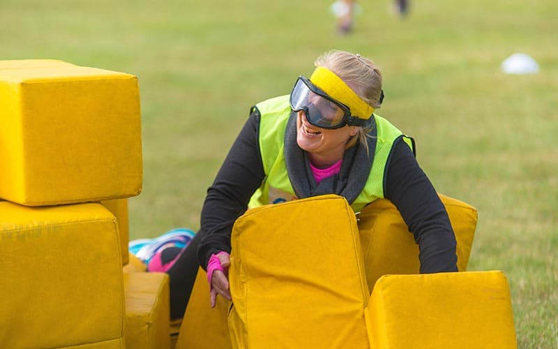 A woman playing on the obstacle course outside