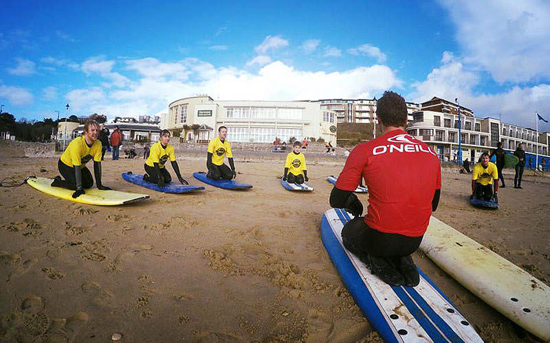 Some people having a surf board lesson in Bournemouth