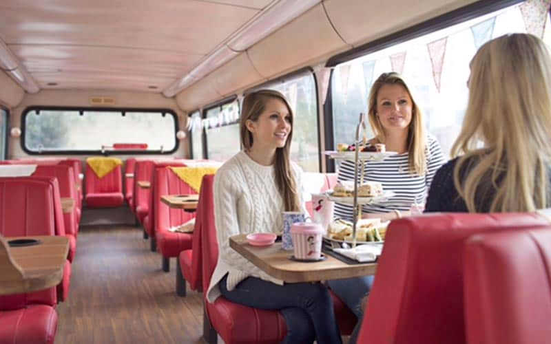 Some women on the bus having an afternoon tea