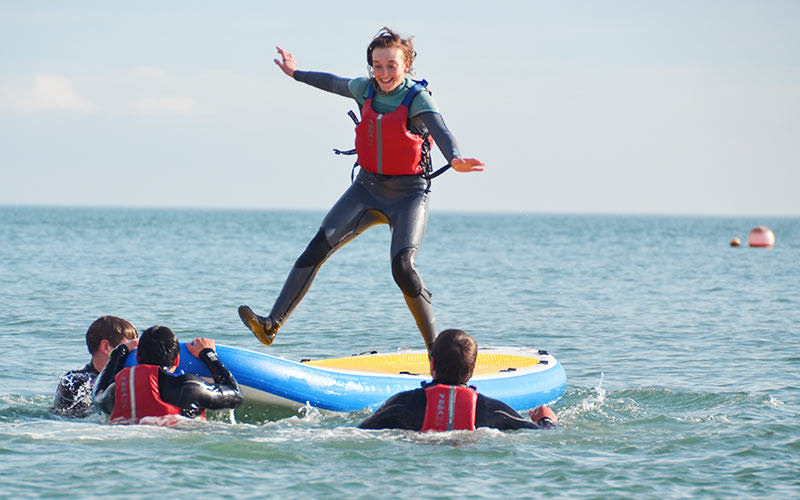 A girl having a paddleboard lesson