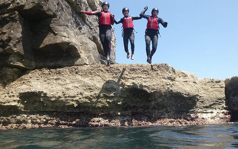 Some girls jumping into the sea