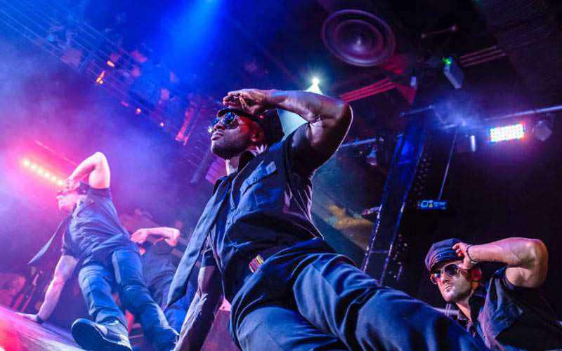 Some strippers performing leaning moves on the stage