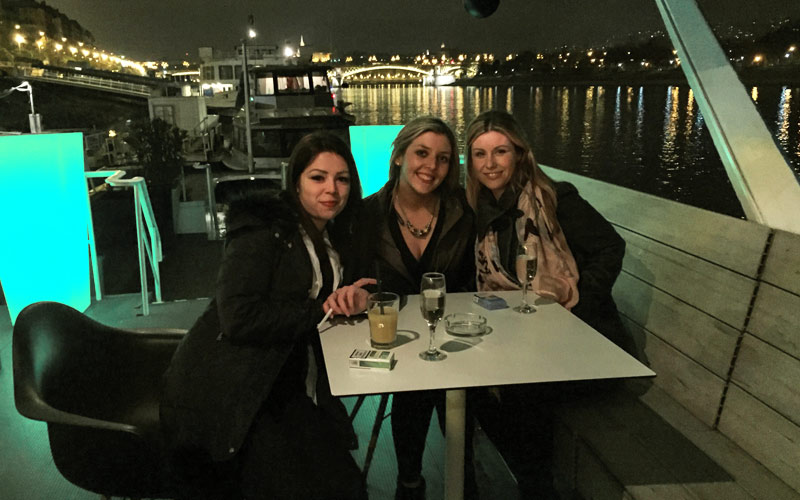 Three girls drinking on the decks of a boat on the River Danube