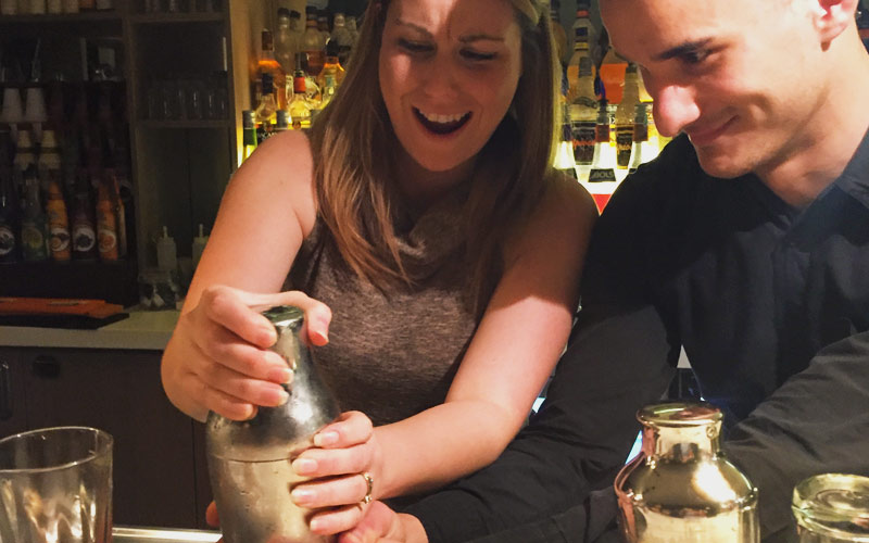 A girl learning how to make her own cocktail