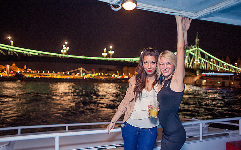 Two girls on a nighttime cruise in Budapest