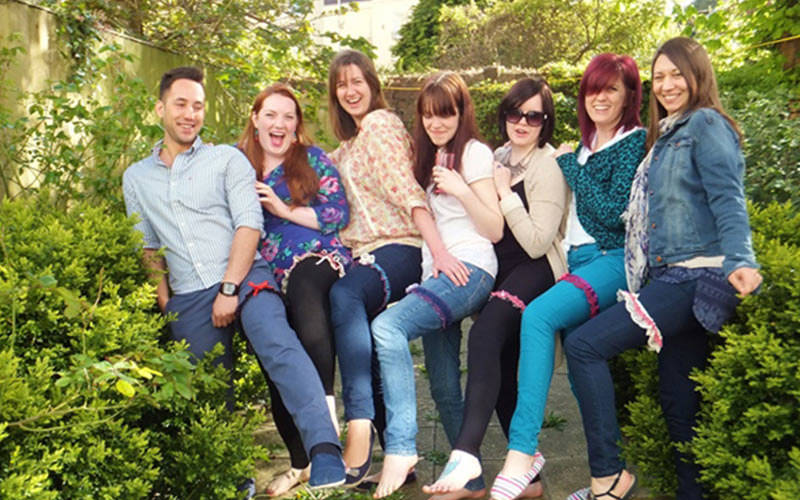 A group of hens and one man showing off their garters