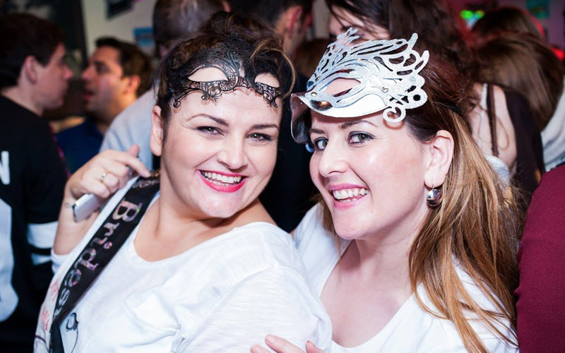 Two girls from a hen party, dressed up in their hen party masks