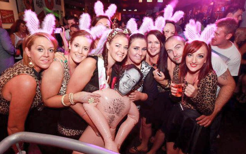 A group of hens with a blow up inflatable man