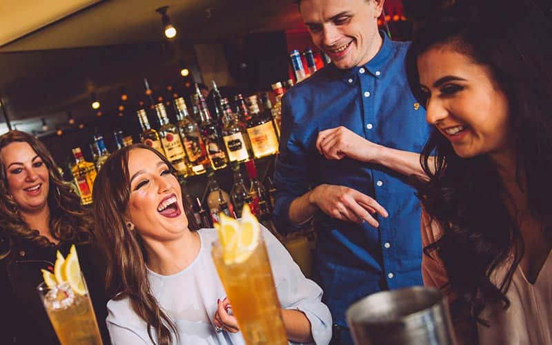 Some women laughing in a cocktails class