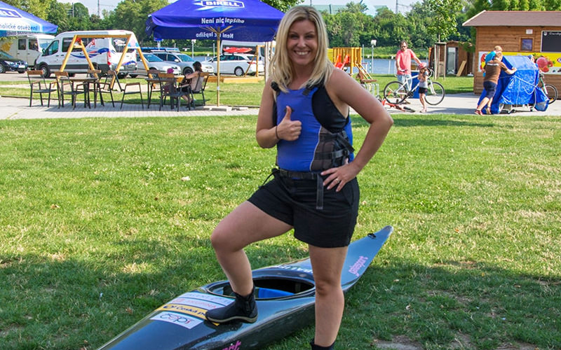 A woman standing on a surfboard, on dry land