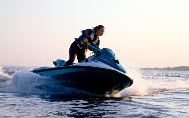 A girl riding a speed boat over the water