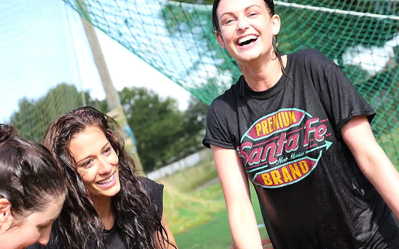A group of women, with wet clothes and hair