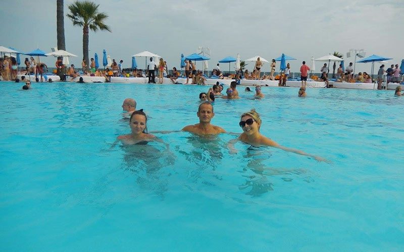 Two women and a man in a beach club in Marbella
