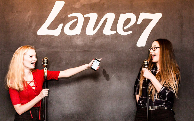 Two girls singing karaoke in Lane7