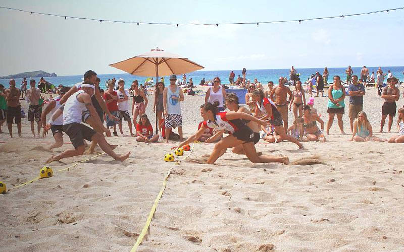 Some people playing volleyball on the beach