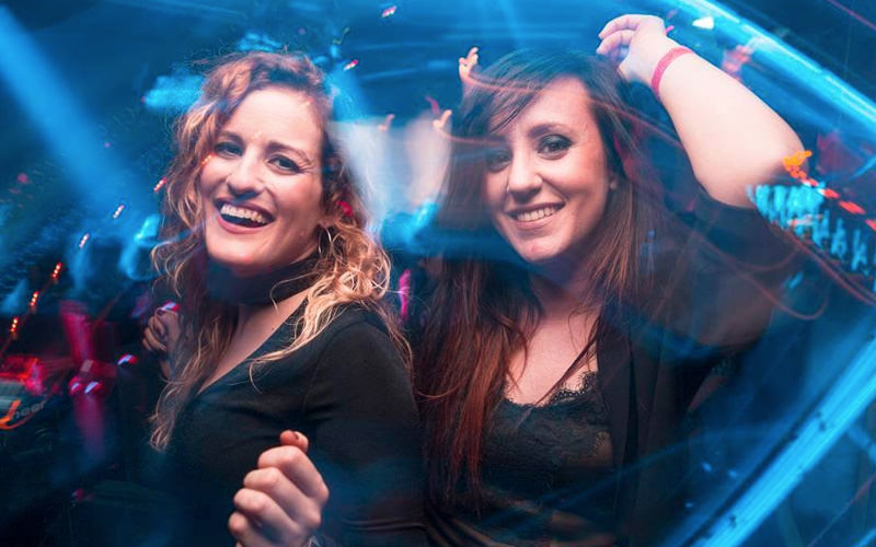 Two girls dancing in a club